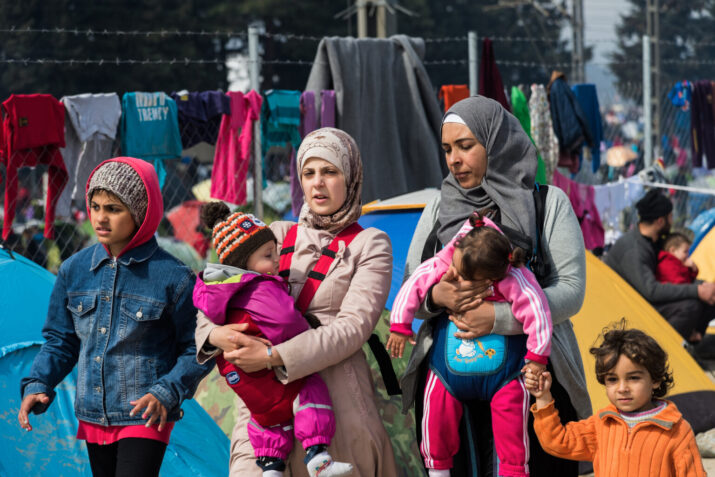 Two Women and four Children walking